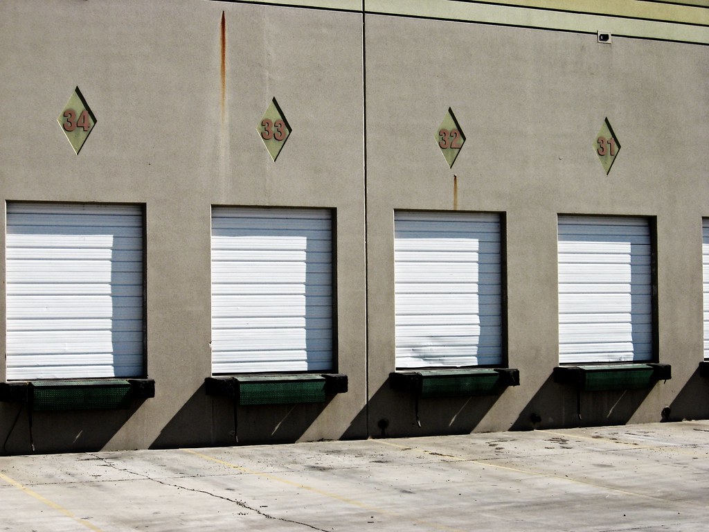 Palletized electrical equipment staged at a warehouse dock